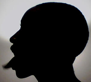 Bald head silhouette sticking out their tongue